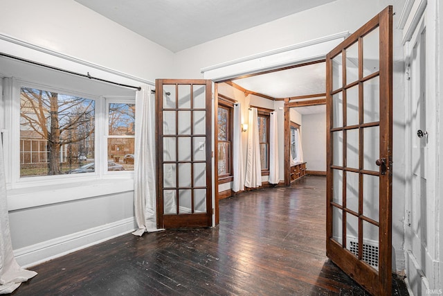 unfurnished room featuring crown molding, french doors, and dark hardwood / wood-style floors