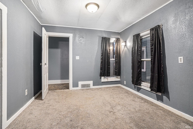 carpeted spare room with crown molding