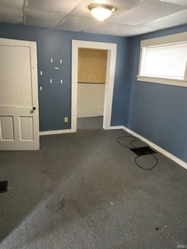 empty room featuring dark carpet