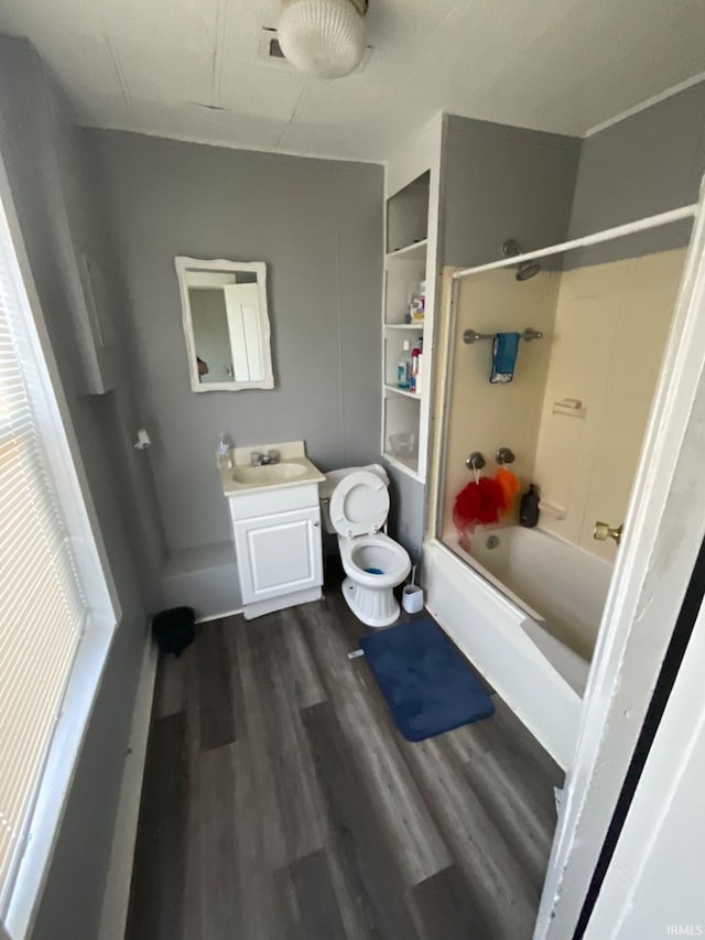 full bathroom with toilet,  shower combination, hardwood / wood-style floors, and vanity