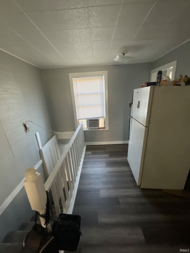 interior space featuring cooling unit, dark hardwood / wood-style floors, and white fridge