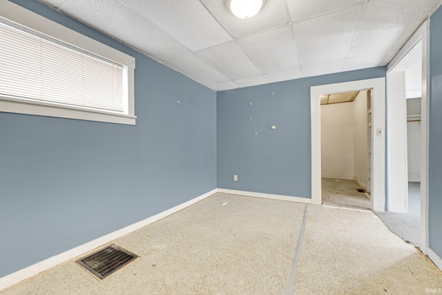 unfurnished bedroom with a paneled ceiling