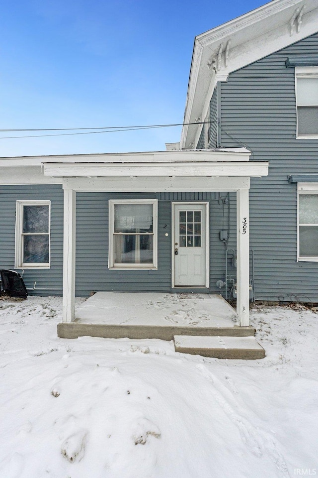 view of snow covered property entrance