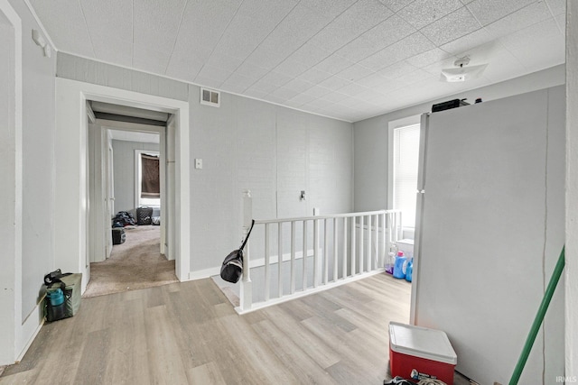 corridor with light wood-type flooring