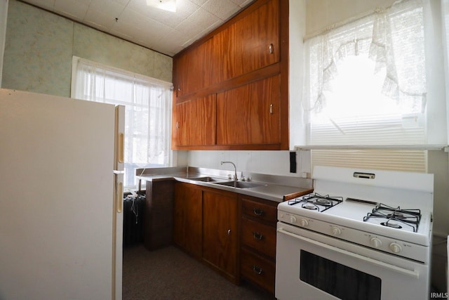 kitchen with sink and white appliances