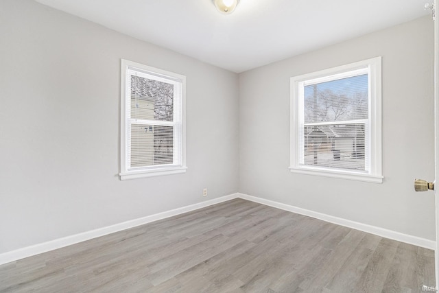 spare room featuring light hardwood / wood-style flooring