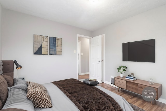 bedroom with hardwood / wood-style floors