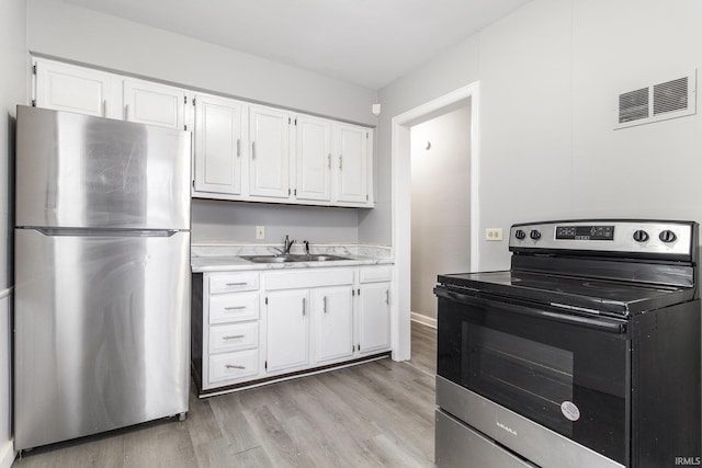 kitchen featuring light hardwood / wood-style flooring, stainless steel appliances, white cabinetry, and sink