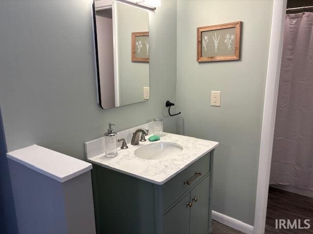 bathroom with hardwood / wood-style floors and vanity