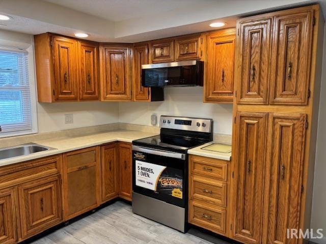 kitchen featuring light hardwood / wood-style flooring, stainless steel appliances, and sink