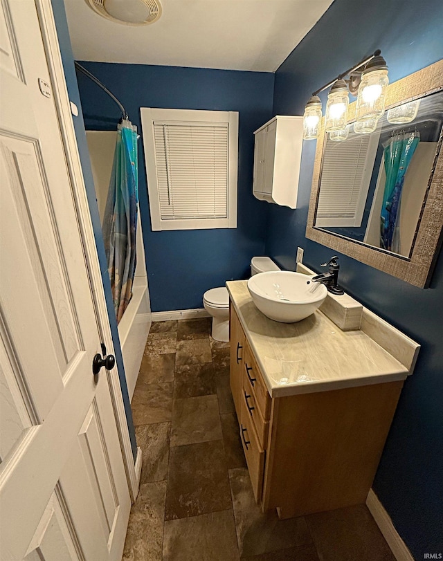 full bathroom with vanity, toilet, and shower / tub combo