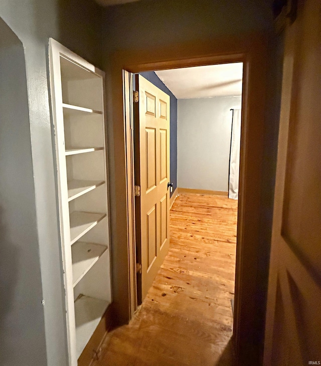 hall with hardwood / wood-style floors