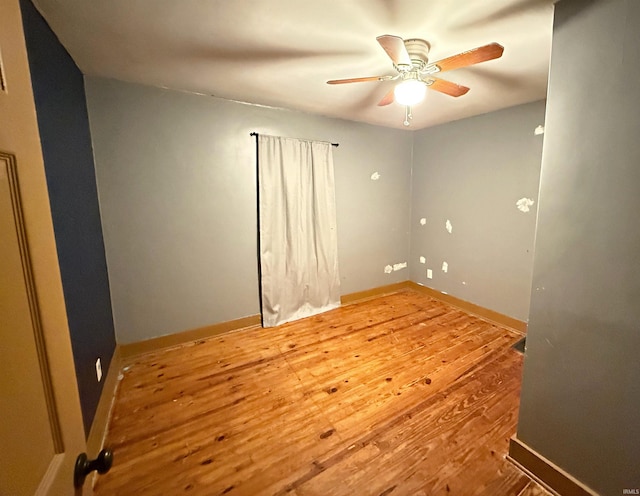 empty room featuring hardwood / wood-style floors and ceiling fan