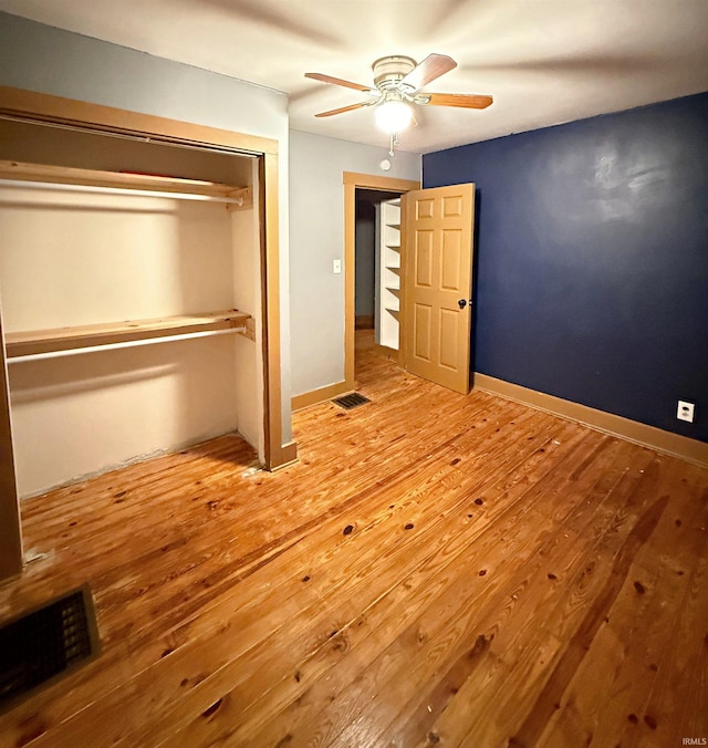 unfurnished bedroom with a closet, light hardwood / wood-style flooring, and ceiling fan