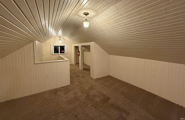 additional living space with carpet floors, vaulted ceiling, wooden walls, and wood ceiling