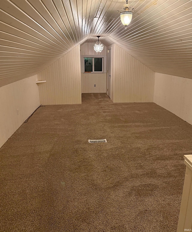 additional living space featuring carpet flooring and vaulted ceiling