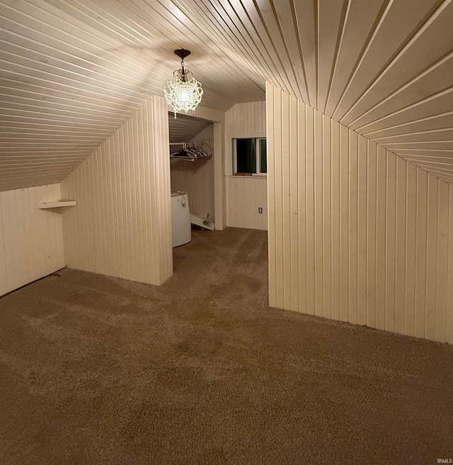 additional living space featuring dark colored carpet, wood walls, lofted ceiling, and wooden ceiling