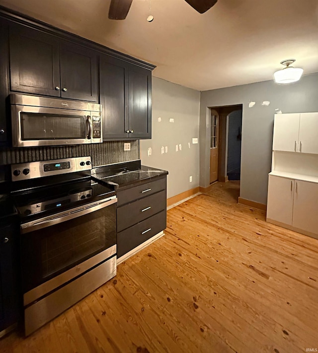 kitchen featuring ceiling fan, light hardwood / wood-style floors, backsplash, and appliances with stainless steel finishes