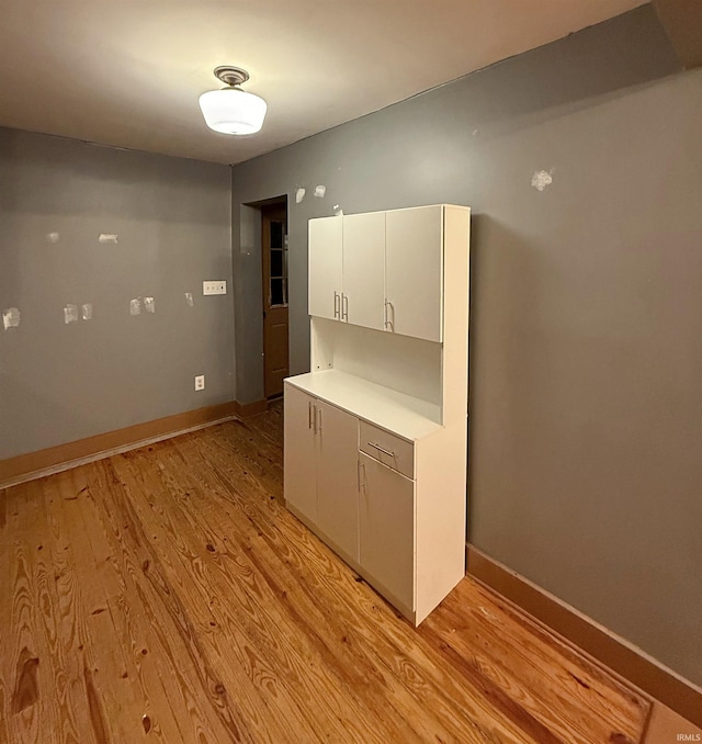 kitchen with white cabinets and light wood-type flooring