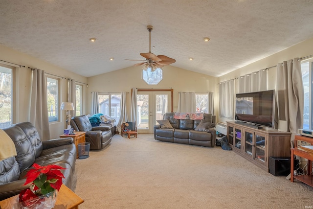 carpeted living room featuring french doors, a textured ceiling, vaulted ceiling, and a healthy amount of sunlight