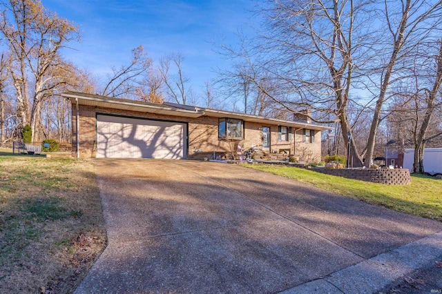 ranch-style house with a garage and a front lawn