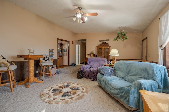 living room featuring light carpet and ceiling fan