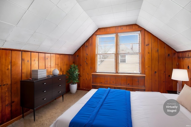 bedroom with wooden walls, light colored carpet, and lofted ceiling