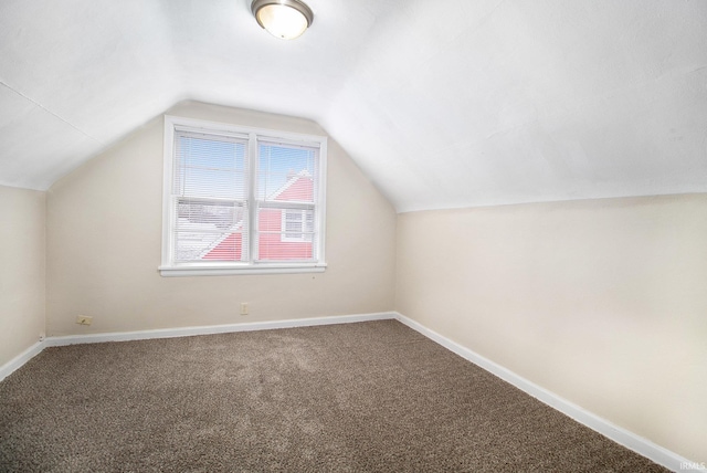 bonus room featuring carpet floors and vaulted ceiling