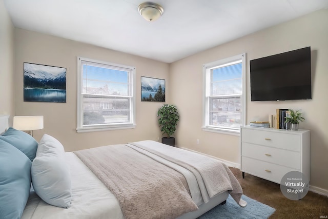 bedroom with carpet and multiple windows