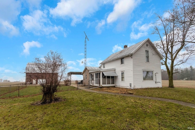 back of house featuring a sunroom, a pergola, and a yard