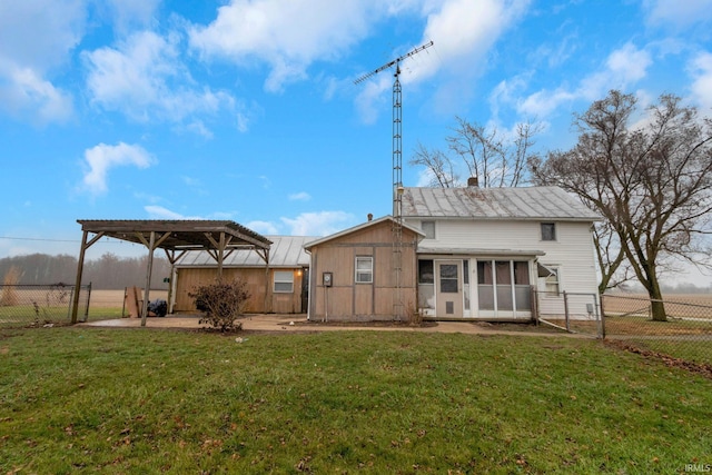 rear view of property with a pergola and a lawn