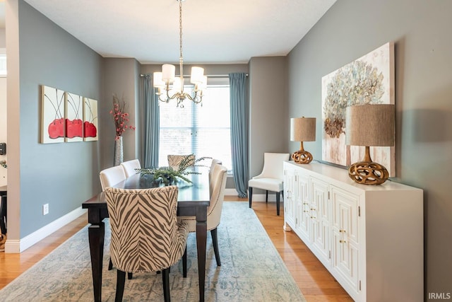 dining room with a chandelier and light hardwood / wood-style flooring