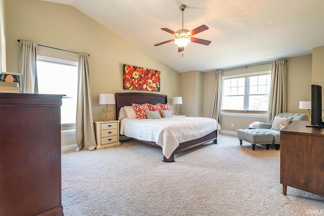 bedroom featuring ceiling fan, light colored carpet, and lofted ceiling