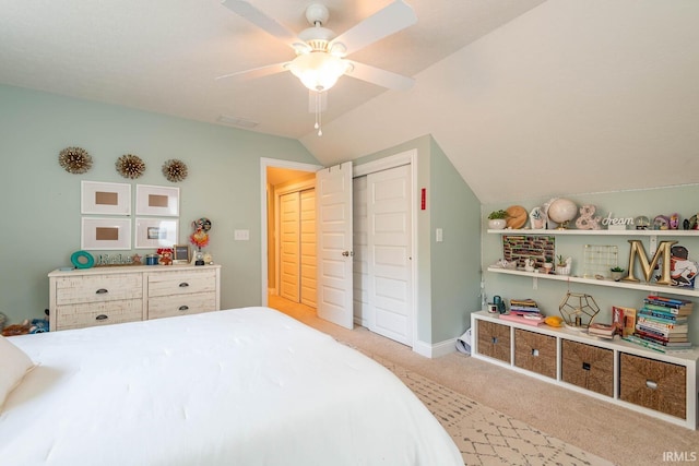 carpeted bedroom with a closet, ceiling fan, and lofted ceiling