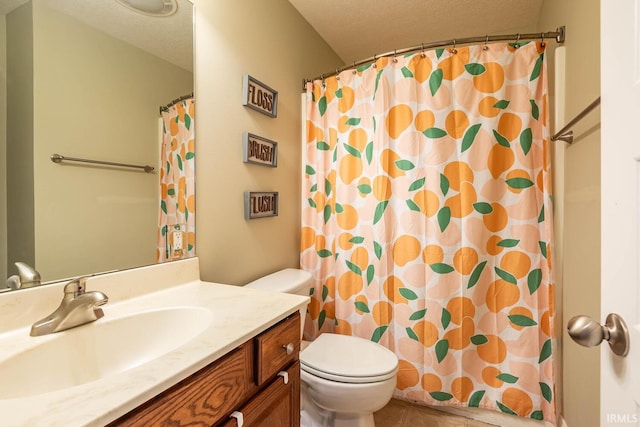 bathroom with vanity, toilet, a textured ceiling, and walk in shower