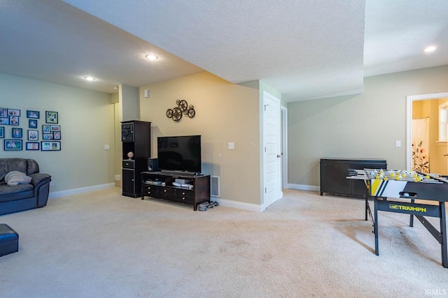 living room with a textured ceiling and light colored carpet