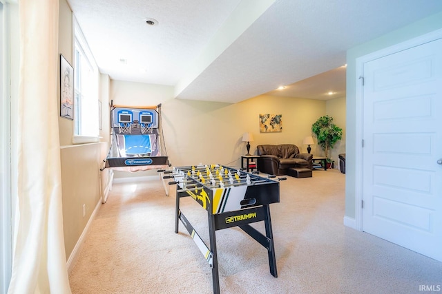 recreation room featuring carpet flooring and a textured ceiling