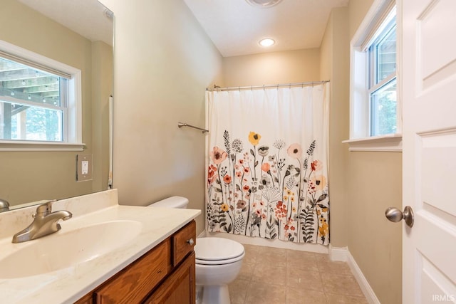 bathroom with toilet, vanity, tile patterned floors, and curtained shower