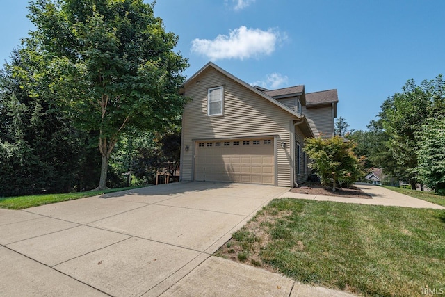 view of front of house with a garage and a front lawn