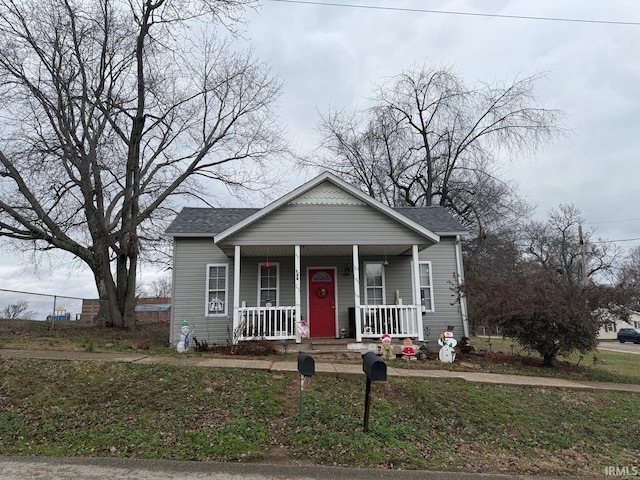 bungalow-style house with covered porch and a front lawn