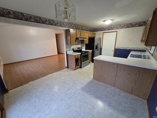 kitchen featuring sink, stainless steel appliances, light hardwood / wood-style flooring, kitchen peninsula, and decorative light fixtures