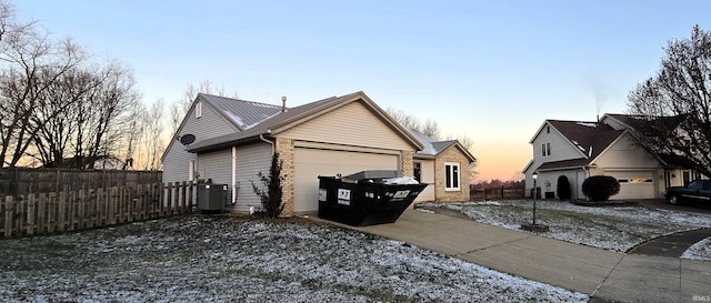 property exterior at dusk featuring a garage and cooling unit