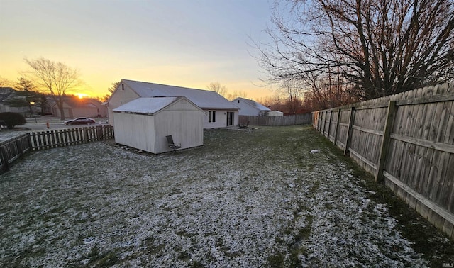 yard at dusk with a storage shed