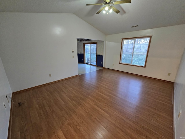 unfurnished room featuring hardwood / wood-style floors, ceiling fan, and vaulted ceiling