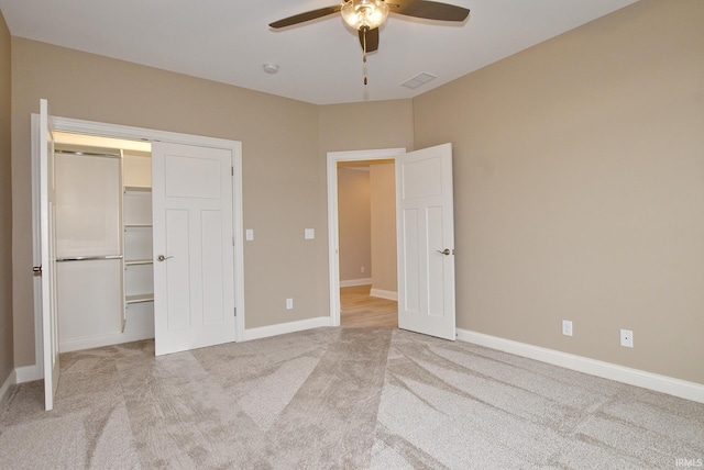 unfurnished bedroom with a closet, ceiling fan, and light colored carpet