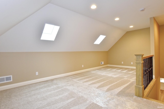 bonus room with carpet and lofted ceiling with skylight