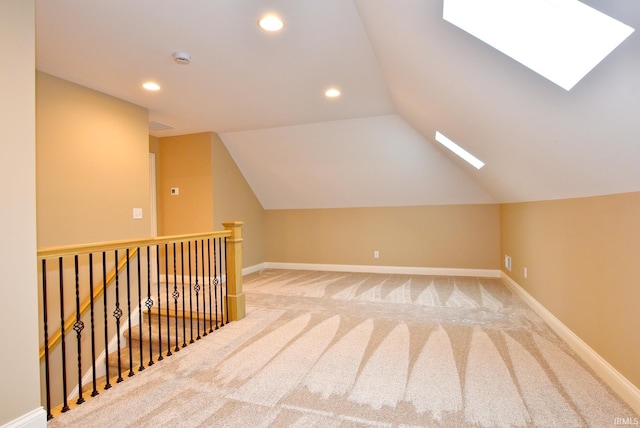 additional living space featuring lofted ceiling with skylight and carpet floors