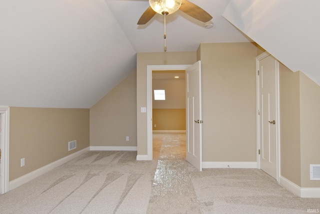 bonus room featuring ceiling fan, light carpet, and vaulted ceiling