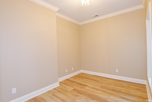 spare room featuring crown molding and hardwood / wood-style floors