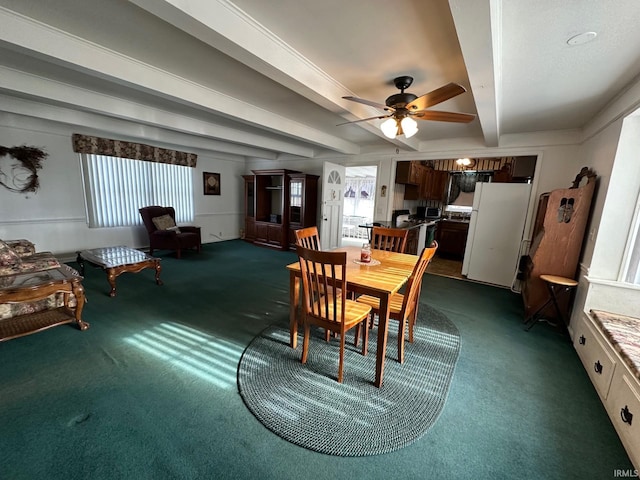 dining room with beamed ceiling, ceiling fan, dark carpet, and a wealth of natural light